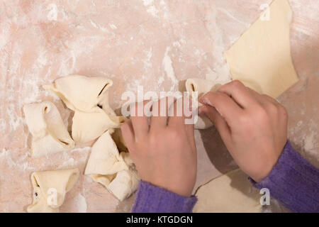Children's hands knead the dough for making delicious cookies Stock Photo