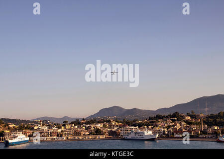 View of airplane over Corfu (Kerkyra) town, cruise ships. It's an island off Greece’s northwest coast in the Ionian Sea. Its cultural heritage reflect Stock Photo