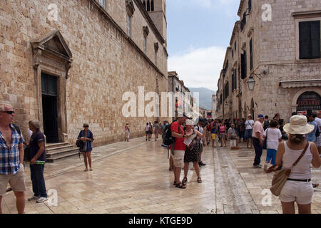 Many tourists walk on street in Dobrovnik old town. It is a city in southern Croatia fronting the Adriatic Sea. Stock Photo