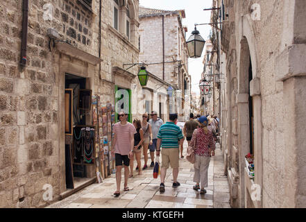 Many tourists walk on street in Dobrovnik old town. It is a city in southern Croatia fronting the Adriatic Sea. Stock Photo