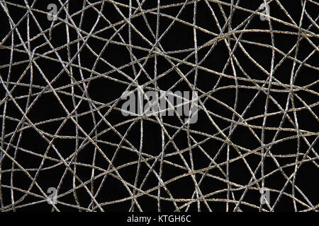 Chaotic weave of silver threads on black, abstract background Stock Photo