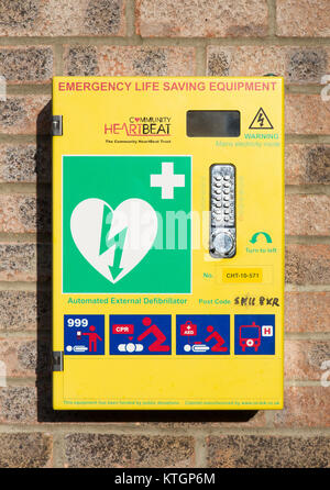 Automated External Defibrillator emergency life saving equipment mounted on wall, Community Heartbeat, Wiltshire, England, UK Stock Photo