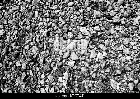 Exterior daytime black and white monochrome high contrast stock photo of beach pebbles on the shores of the Long Island Sound in Stamford, Connecticut Stock Photo