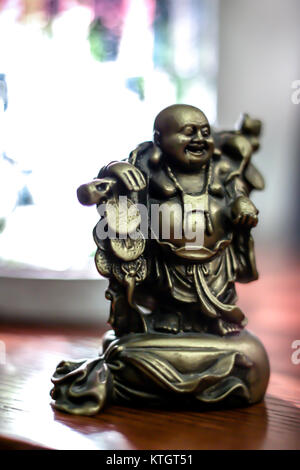 Interior shallow depth of field low light stock photo of bronze buddha statue Stock Photo
