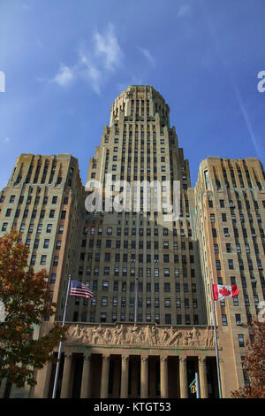 Buffalo City Hall in the day with blue semi cloudless sky and American and Canadian flags flying in the foreground in Buffalo, New York in Erie County Stock Photo