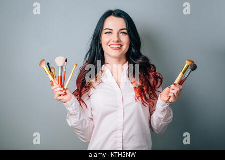 make up artist woman with makeup brushes near face. beauty concept Stock Photo