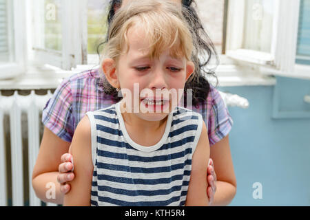 Preschooler child is cry after she has received vaccine, injection at doctor's office. Stock Photo