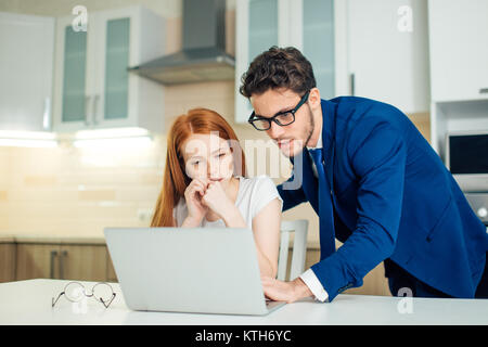 Two analysts discussing online data in front of laptop Stock Photo