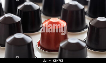 Collection of red and black espresso coffee capsules on white background, Closeup view with details Stock Photo