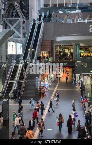 JAPAN, TOKYO-CIRCA APR, 2013: People walk largest hall of Kyoto rail station. It is a major railway station and transportation hub. Building includes  Stock Photo