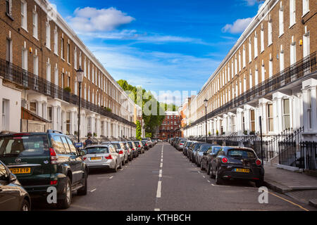 LONDON, UK - JUNE 16, 2013: Cars parked along residental victorian town houses at Redburn Street in Chelsea West London Stock Photo
