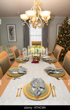 A formal dining room with table set, decorated for the Christmas holiday Stock Photo