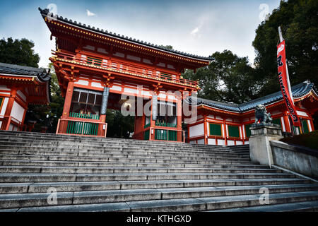 License and prints at MaximImages.com - Yasaka shrine, Yasaka-jinja bright orange main entrance gate low angle view in morning sunrise Gion, Kyoto, Ja Stock Photo