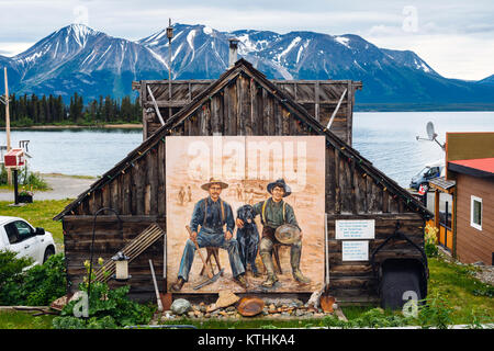 A mural of two gold miners in the small, remote village of Atlin in northern British Columbia, Canada Stock Photo