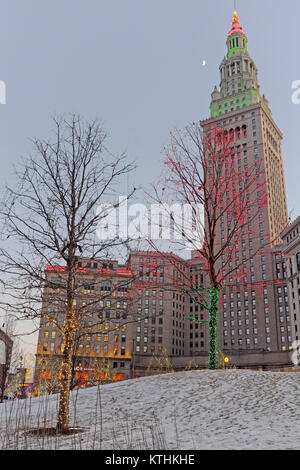 A festive atmosphere on Christmas Day 2017 is enhanced by the colored lights of public square and the iconic Tower City Center behind it. Stock Photo