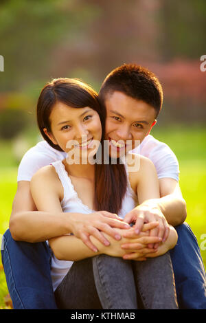 Young Chinese lover holding together in the park Stock Photo