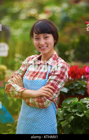 One Beautiful Chinese Woman Working in the Florist's Smile at Camera Stock Photo