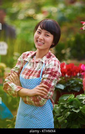 One Beautiful Chinese Woman Working in the Florist's Smile at Camera Stock Photo