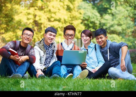 group of fice happy asian college students using laptop in campus Stock Photo