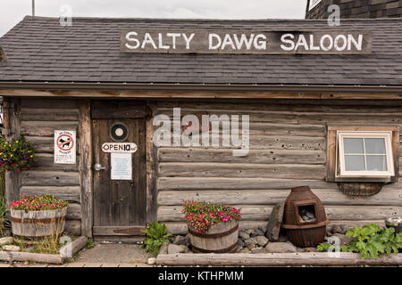 Famous Salty Dawg Saloon in the original log cabin built in 1897 along the marsh boardwalk on Homer Spit on Kamishak Bay in Homer, Alaska. Stock Photo