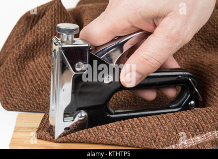 Heavy duty staple gun with staples on the white background Stock Photo