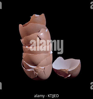 Stack of broken egg shells on a black background Stock Photo