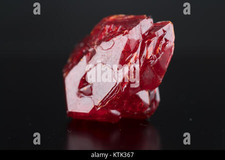 Red natural crystal mineral on a black background Stock Photo