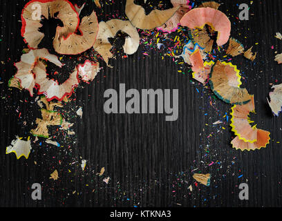 Bright colored abstraction on a dark background. Chips of crayons. Stock Photo