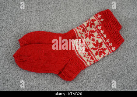 a pair of traditional red Christmas sock on a gray background Stock Photo