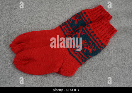 a pair of traditional red Christmas sock with deers on a gray background Stock Photo