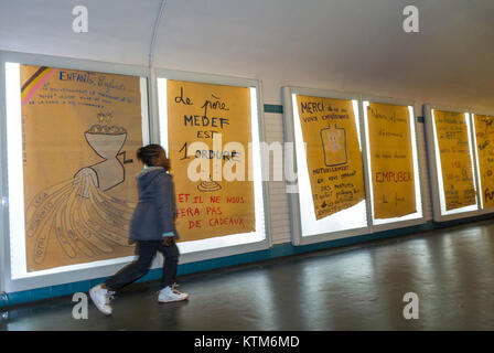 Paris, France, Anti French Advertising Protest Art, Metro Subway Ad Posters on wall, Walking in Hallway of Invalides Station, protests france Stock Photo