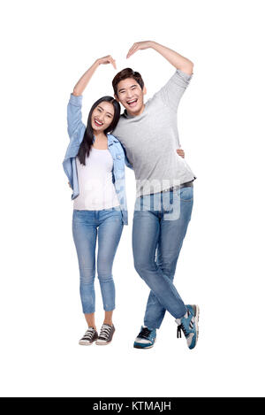 Portrait of asian couple making heart shape with hands posing isolated over white background Stock Photo