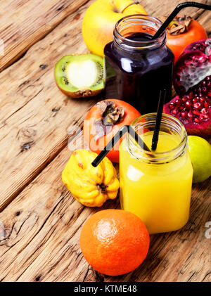 Summer soft juice from fresh fruit. Drink from apples, pomegranate, persimmons and kiwi Stock Photo