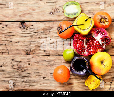 Summer soft juice from fresh fruit. Drink from apples, pomegranate, persimmons and kiwi Stock Photo