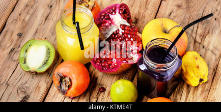 Summer soft juice from fresh fruit. Drink from apples, pomegranate, persimmons and kiwi Stock Photo