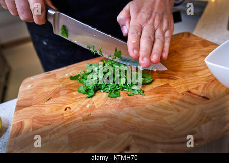 Food preparation - dicing Coriander on chopping board Stock Photo