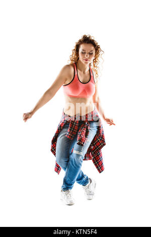 Young happy hispanic woman dancing against white background. Fit dancer girl doing aerobic exercises isolated on white Stock Photo