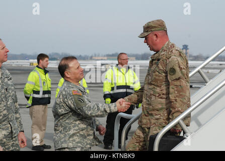 ALBANY, N.Y. – New York Army National Guard Col. Phil Pugliese, Chief of Staff of the 42nd Infantry Division, welcomes home Sgt. 1st Class Nicholas Kachiros here Jan. 8 at Albany International Airport.  Kachiros arrived with some 200 other Soldiers from the 427th Brigade Support Battalion’s Headquarters Company and Company B following demobilization at Camp Shelby, Miss.  The Soldiers served in Kuwait or Afghanistan as part of the 27th Infantry Brigade Combat Team’s overseas service in 2012.  U.S. Army photo by Col. Richard Goldenberg (RELEASED). Stock Photo