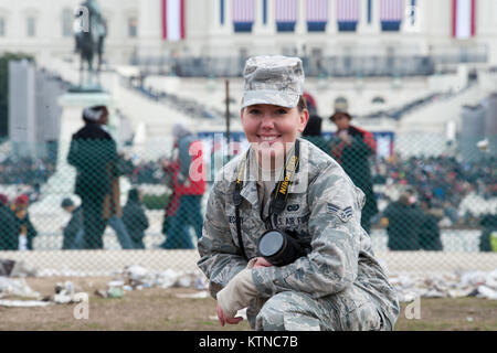 WASHINGTON, D.C. — –  Air Force Public Affairs specialist Senior Airman Andrea Liechti, from the 115th Fighter Wing Wisconsin Air National Guard, takes a photo in front of the U.S. Capitol Building.   The 57th Presidential Inauguration was held in Washington D.C. on Monday, January 21, 2013. The Inauguration included the Presidential Swearing-in Ceremony, Inaugural Address, Inaugural Parade and numerous inaugural balls and galas honoring the elected President of the United States. During the 10-day inaugural period approximately 6,000 National Guard personnel from over 30 states and territorie Stock Photo