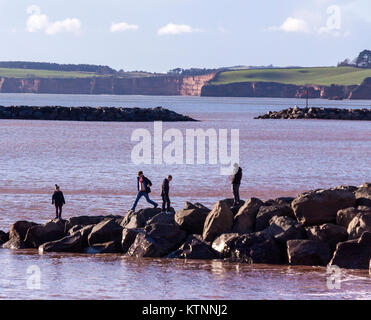 Sidmouth, Devon. 27th Dec, 2017. UK Weather. Despite freezing temperatures and a bitingly cold wind, families and children were out playing on the rocks at Sidmouth, Devon. Credit: Photo Central/Alamy Live News Stock Photo