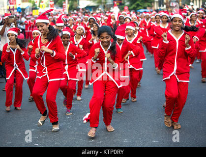 girls wearing santa's clothes performimg flash mob participating in buon natale thrissur christmas festival 2017 ,thrissur,Kerala,india.More 5000 santa's participated in this event.it's an annual christmas event conducted by thrissur district christian community an unique christian community festival in kerala and india. Stock Photo