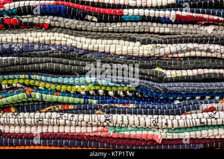 Close up image of several colorful rugs piled on each other Stock Photo