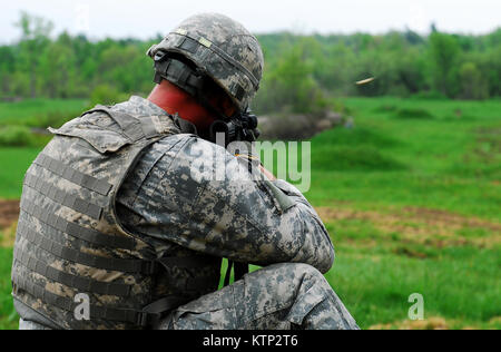 Sgt. Bradley Quick, an infantryman with Headquarters Company, 27th Infantry Brigade Combat Team fires an M4 carbine during individual weapons qualification at Fort Drum on May 16. Guardsman are expected to maintain a high level of marksmanship, and qualify each year on their assigned weapon (US Army photo by Spc. Alexander Rector). Stock Photo