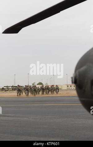 Saudi Arabian soldiers prepare to load into armored personnel carriers ...