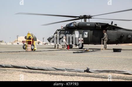 Soldiers from Company C, 1st Battalion, 214th Air Ambulance (Medevac), now with the 42nd Combat Aviation Brigade, conduct a personnel recovery exercise simulating a down aircraft on May 14, 2014, in the Arabian Gulf.  The Medevac is deployed to Kuwait in support of Operation Enduring Freedom, and conducts both operational missions and exercises in the region. (N.Y. Army National Guard photo by Sgt. Harley Jelis/Released) Stock Photo