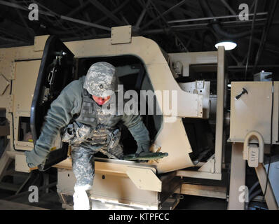 A 42nd Infantry Division Soldier emerges from the Humvee rollover training  simulator on Feb. 25 at Camp Smith Training Site before as a group of 42nd Soldiers certify on the simulator as part of their pre-mobilization training before deploying to Guantanamo Bay, Cuba. Photo by Sgt. 1st class Steven Petibone, 42nd Infantry Division. Stock Photo