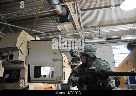 A 42nd Infantry Division Soldier emerges from the Humvee rollover training  simulator on Feb. 25 at Camp Smith Training Site before as a group of 42nd Soldiers certify on the simulator as part of their pre-mobilization training before deploying to Guantanamo Bay, Cuba. Photo by Sgt. 1st class Steven Petibone, 42nd Infantry Division. Stock Photo