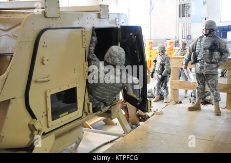 A 42nd Infantry Division Soldier emerges from the Humvee rollover training  simulator on Feb. 25 at Camp Smith Training Site before as a group of 42nd Soldiers certify on the simulator as part of their pre-mobilization training before deploying to Guantanamo Bay, Cuba. Photo by Sgt. 1st class Steven Petibone, 42nd Infantry Division. Stock Photo