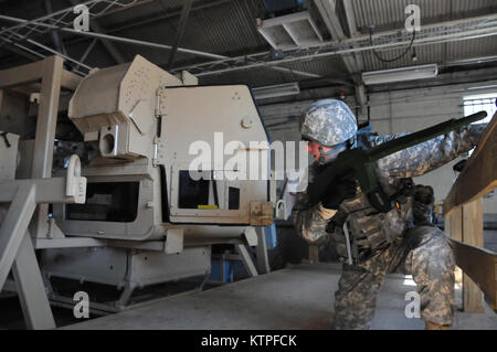 A 42nd Infantry Division Soldier emerges from the Humvee rollover training  simulator on Feb. 25 at Camp Smith Training Site before as a group of 42nd Soldiers certify on the simulator as part of their pre-mobilization training before deploying to Guantanamo Bay, Cuba. Photo by Sgt. 1st class Steven Petibone, 42nd Infantry Division. Stock Photo