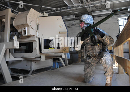 A 42nd Infantry Division Soldier emerges from the Humvee rollover training  simulator on Feb. 25 at Camp Smith Training Site before as a group of 42nd Soldiers certify on the simulator as part of their pre-mobilization training before deploying to Guantanamo Bay, Cuba. Photo by Sgt. 1st class Steven Petibone, 42nd Infantry Division. Stock Photo